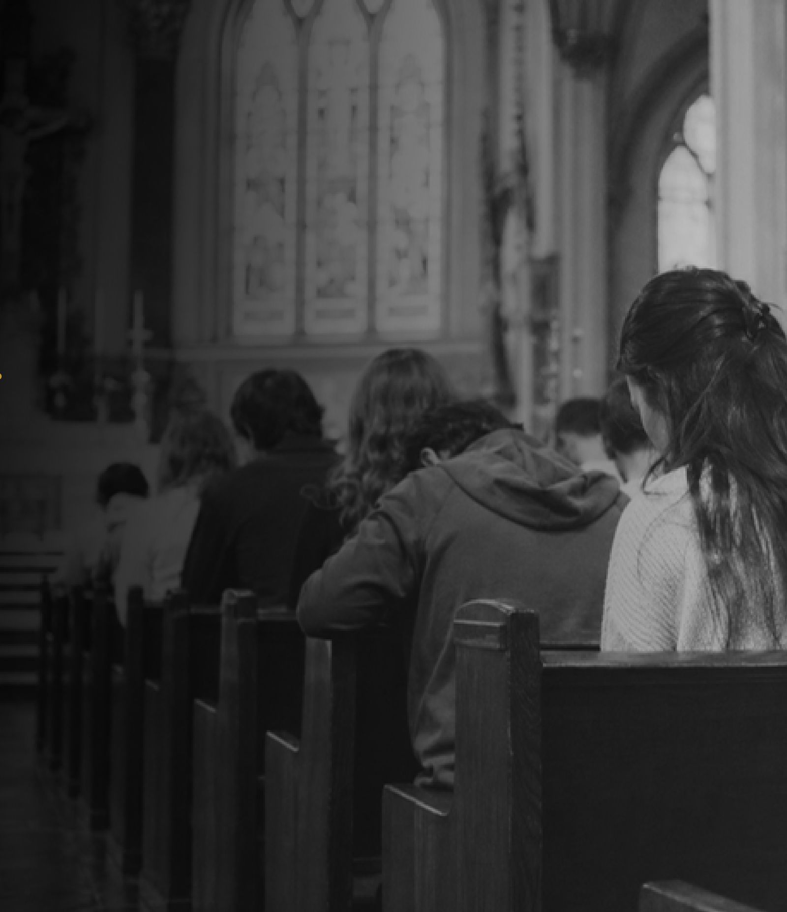 Believers bowed in prayer together inside a church